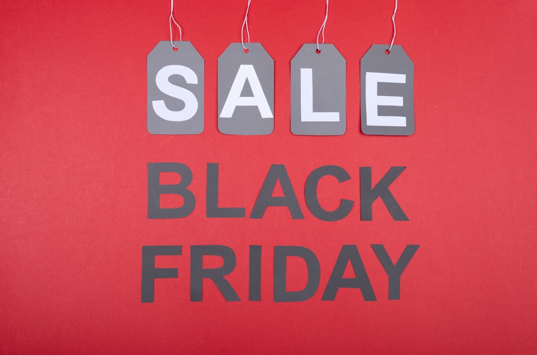 'Sale' price tags above bold 'Black Friday' lettering on red